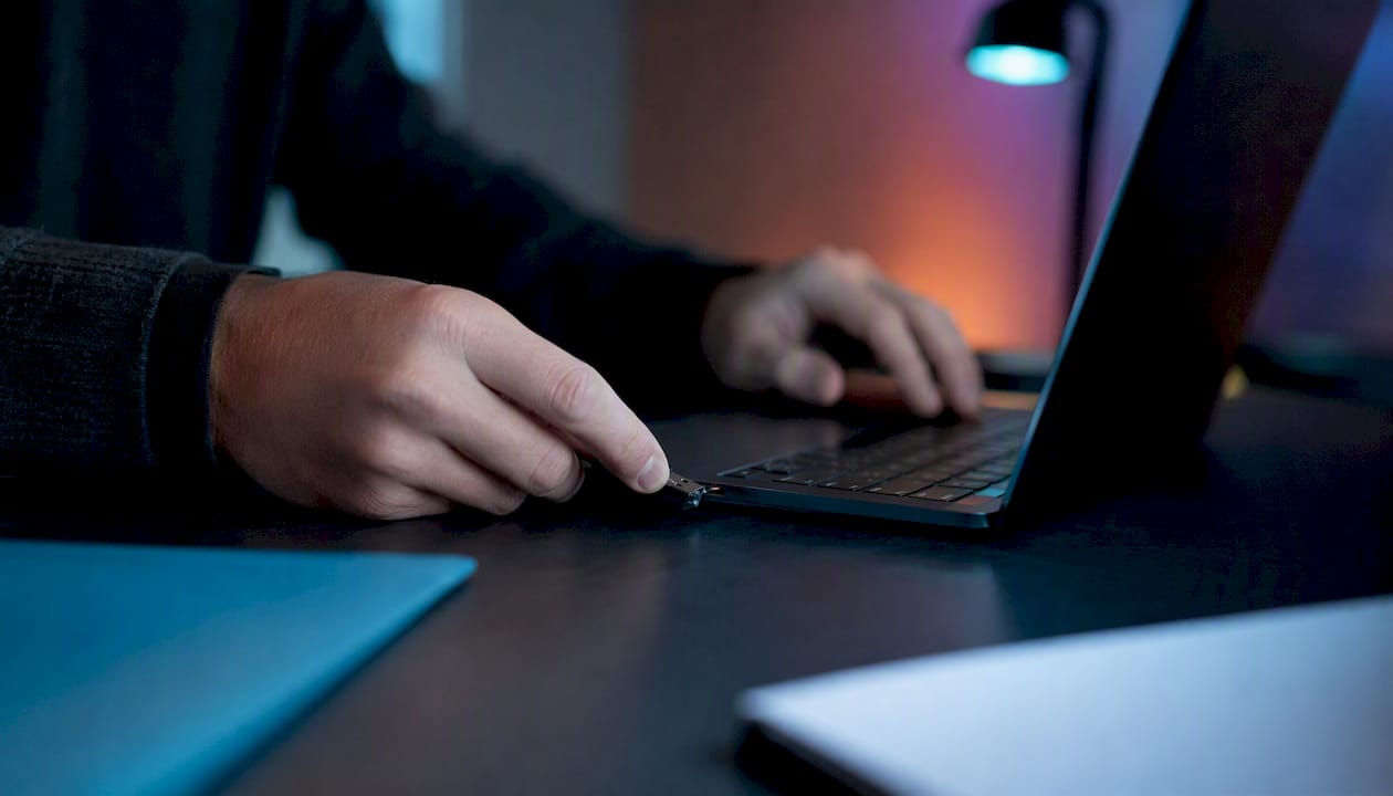Hands inserting USB to import project data