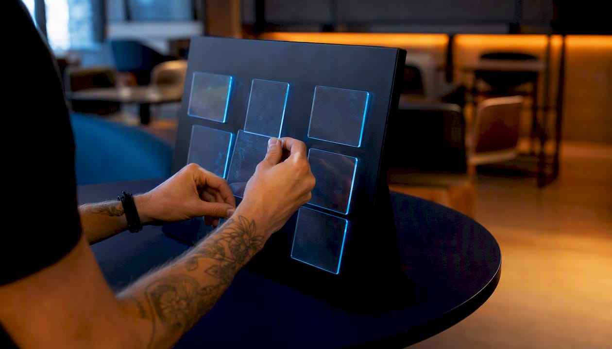 Hands organizing neon-edged task cards on board