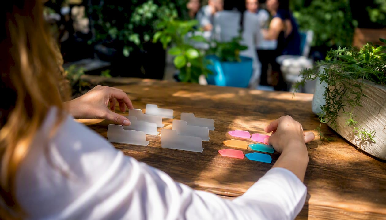 Hands sorting digital folders and tags icons