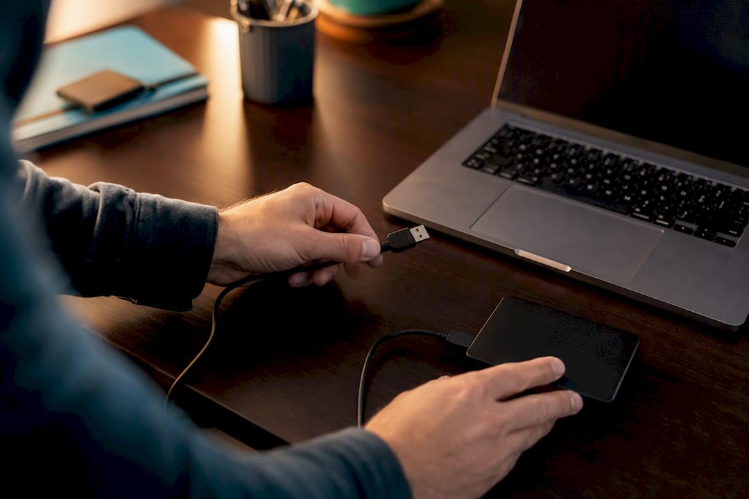 Hands connecting external storage device