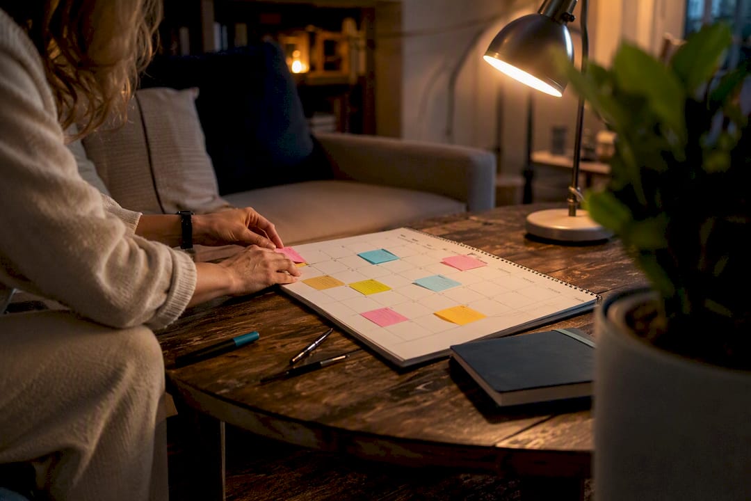 Hands adjusting calendar and notes