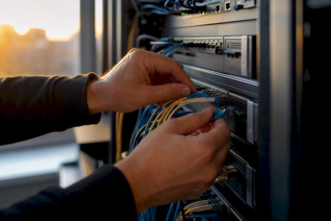 Engineer adjusting network cables on cloud infrastructure