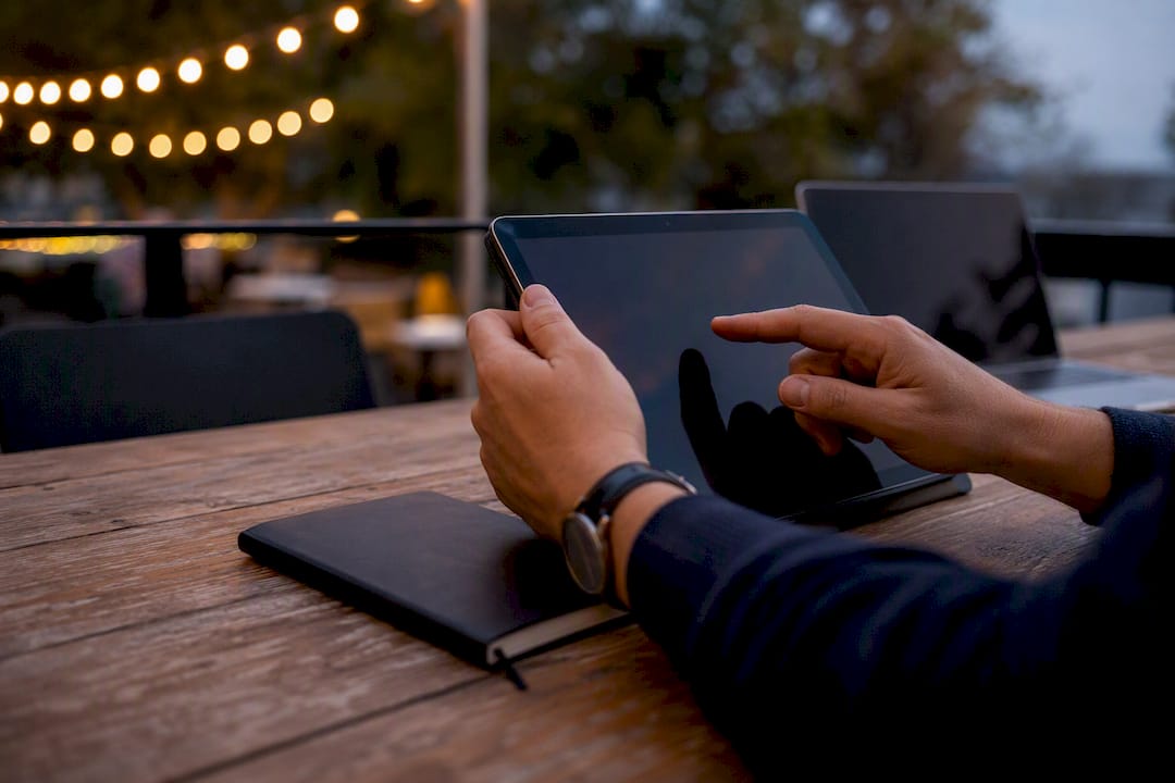 Hands adjusting SaaS pricing dashboard on tablet