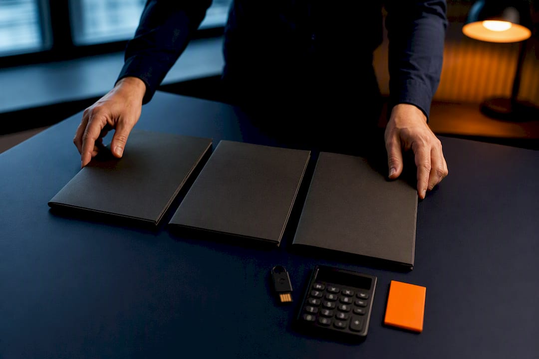 Hands arranging SaaS diligence evidence folders