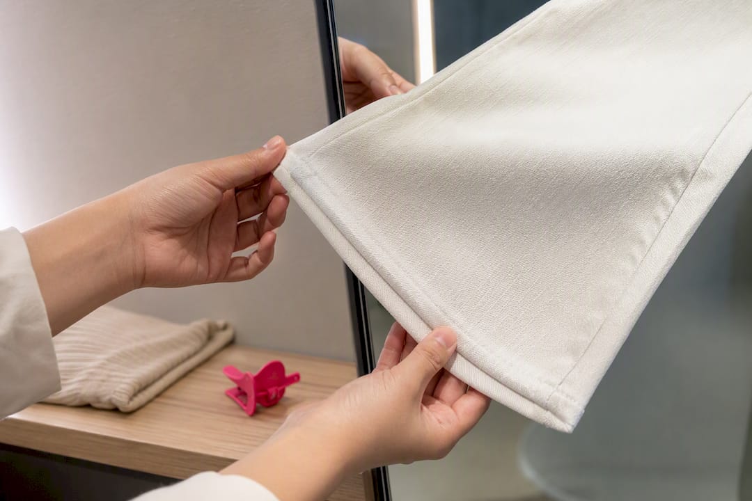 Hands checking white denim opacity
