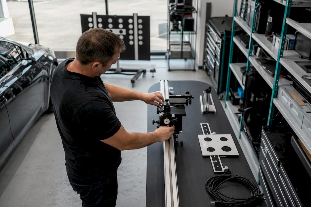 Technician calibrating ADAS sensor device