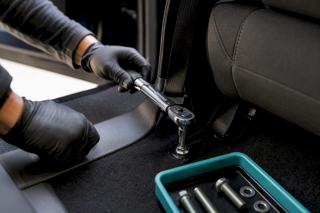 Torque wrench on seat belt anchor bolt