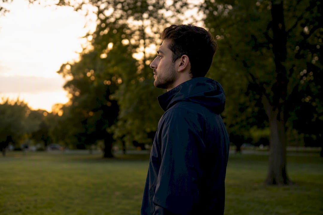 Silhouette of person in thoughtful reflection outdoors