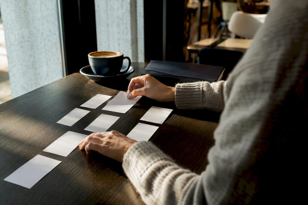 Hands sorting interview feedback cards
