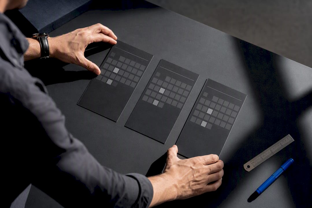 Hands arranging a three-month interview plan