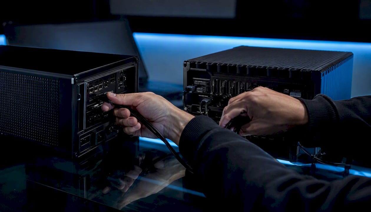 Hands swapping cables between two AI hardware units