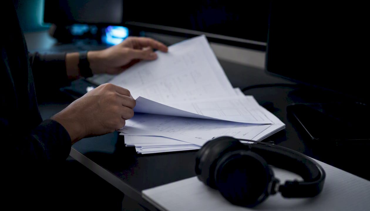 Hands reviewing AI agent output mock-ups
