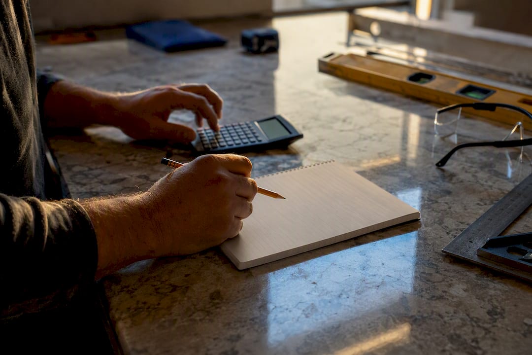 Contractor hands calculating project costs