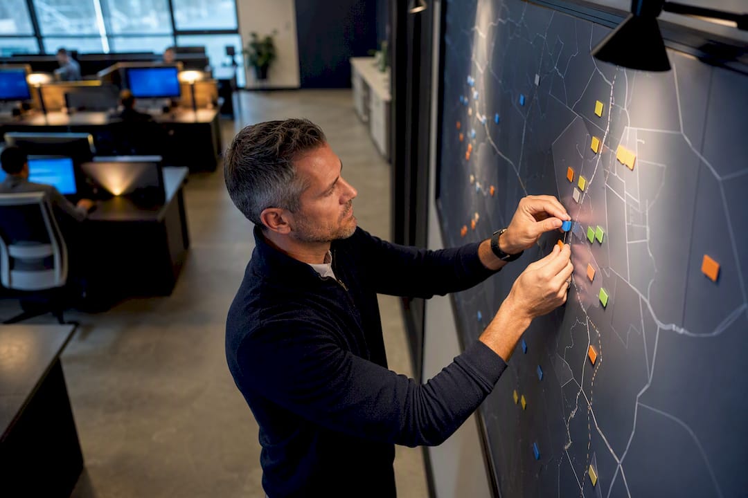Manager arranging technician scheduling board