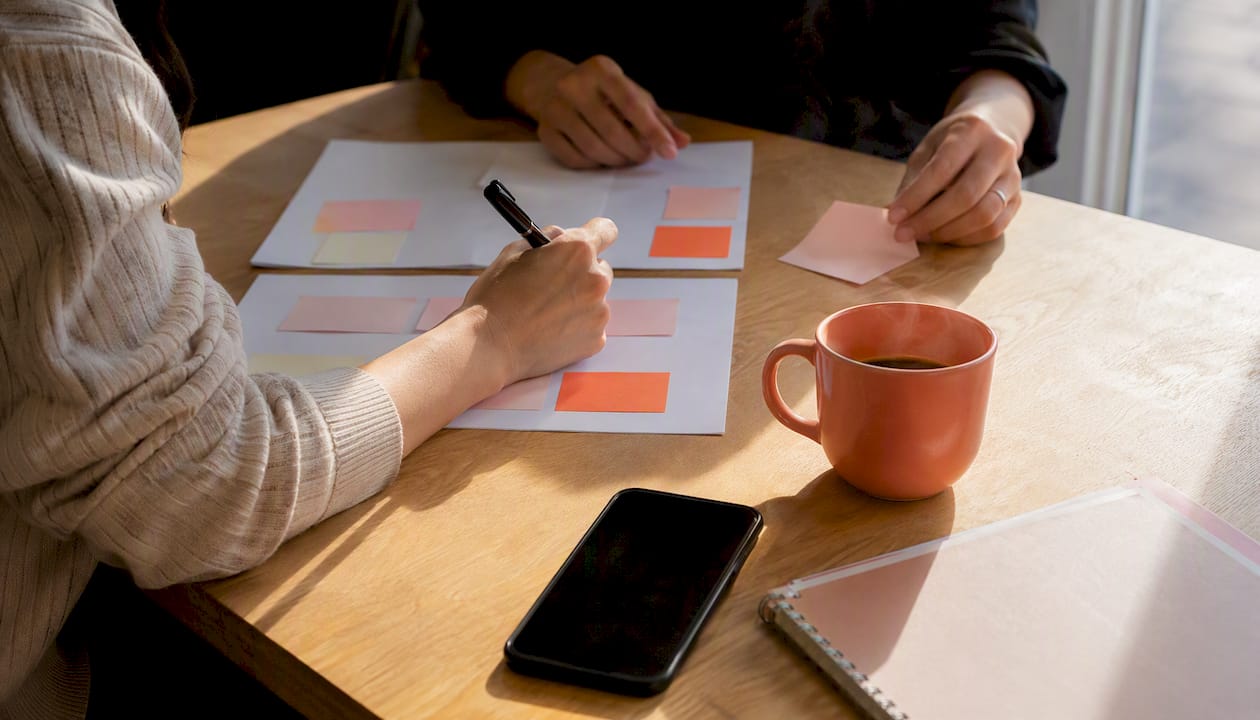 Workspace with collaboration tools and coral mug