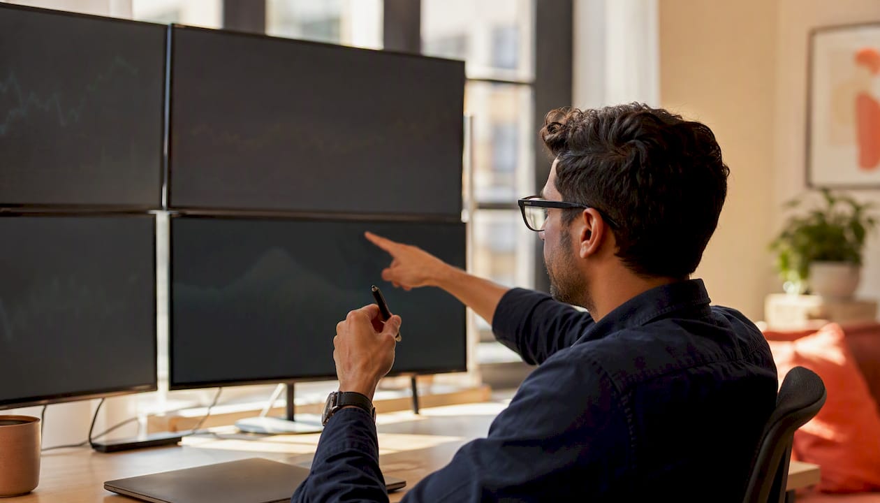 Hands analyzing charts of social media bot detection signals