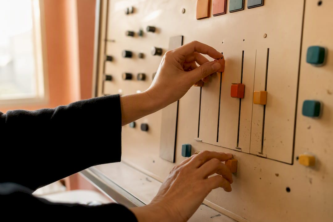 Hands adjusting campaign controls on dial