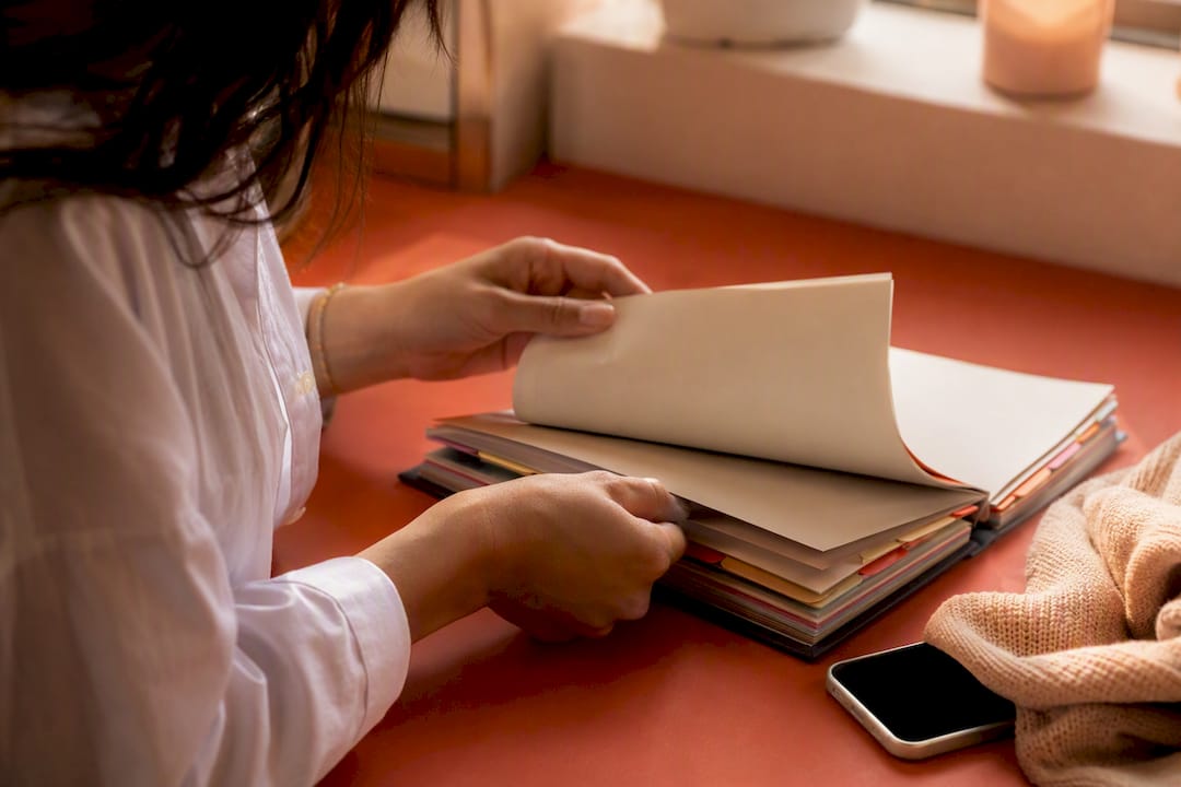 Hands managing brand exclusivity ledger