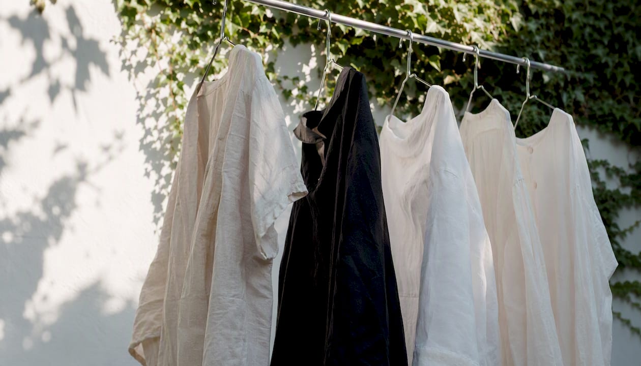 Linen clothes air drying on clothesline in shade