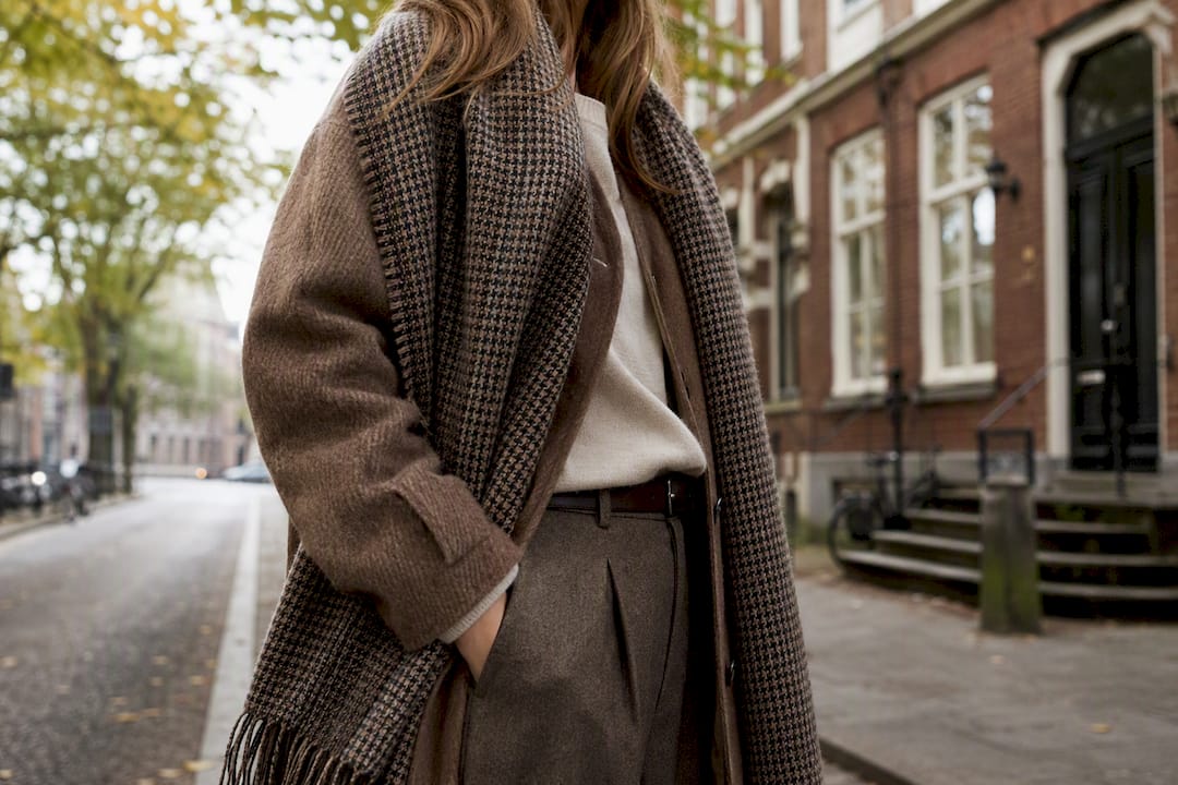 Woman layered in tactile outerwear and velvet textile