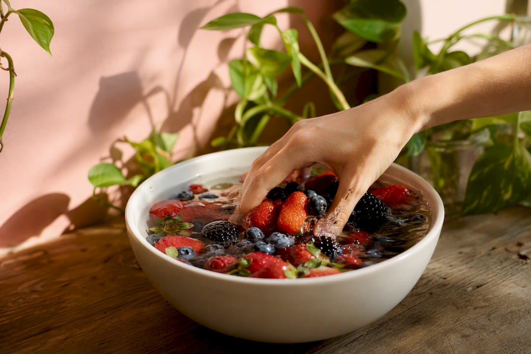 Fresh fruit soaking in vinegar water solution