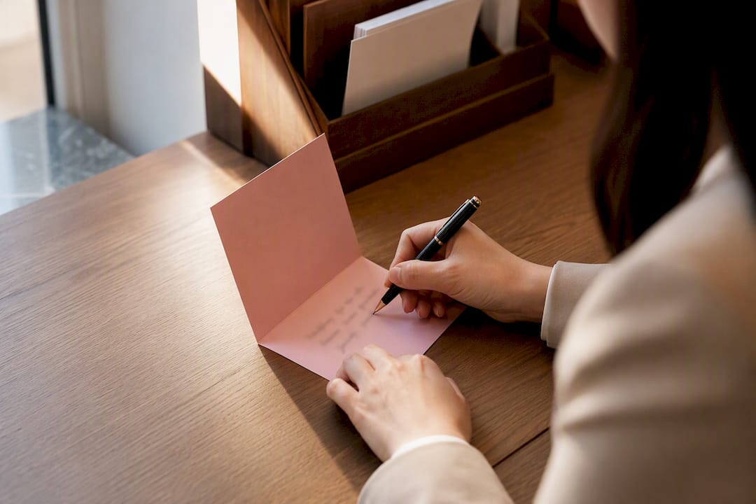 Hand writing a corporate thank-you card