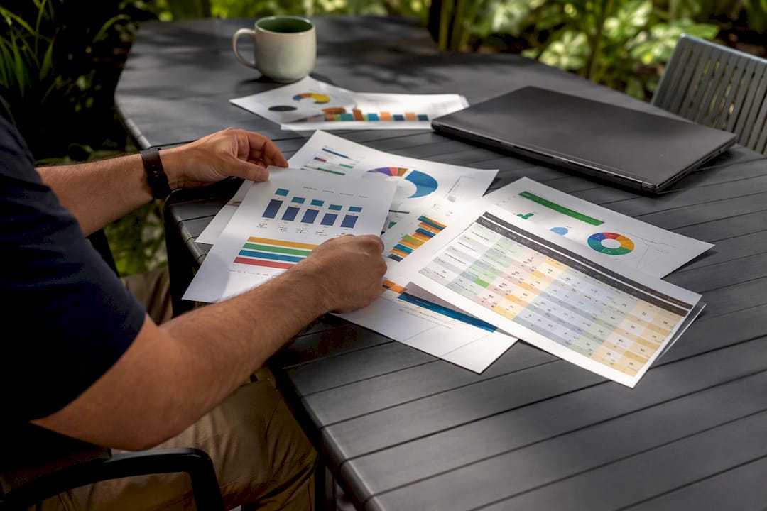 Hands holding ETF portfolio and stock certificates