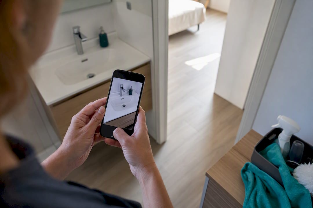 Cleaner taking a timestamped photo with a smartphone