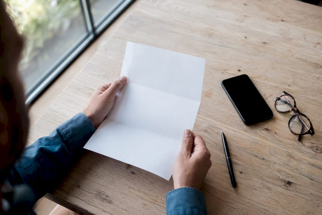 Hands preparing documents and phone for signature