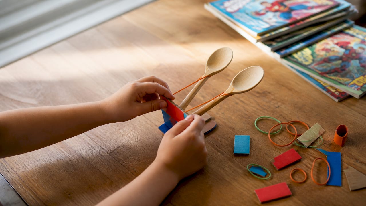 Child hands assembling physics experiment parts