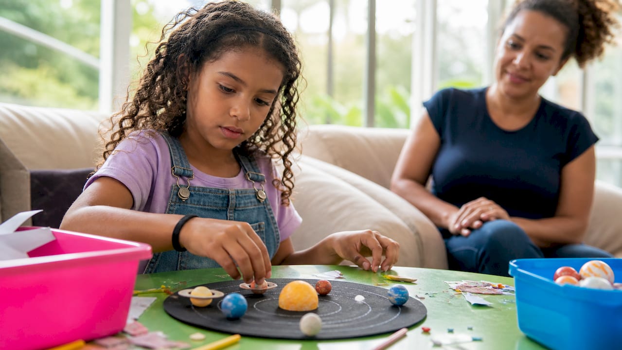Parent quietly observing child's science project