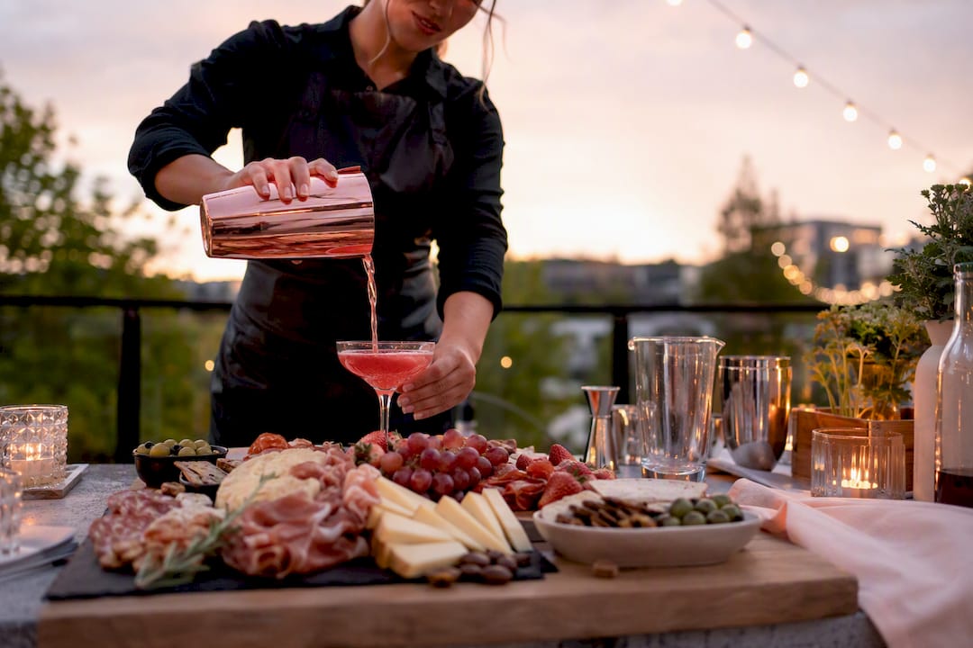Grazing board and bartender pouring cocktail