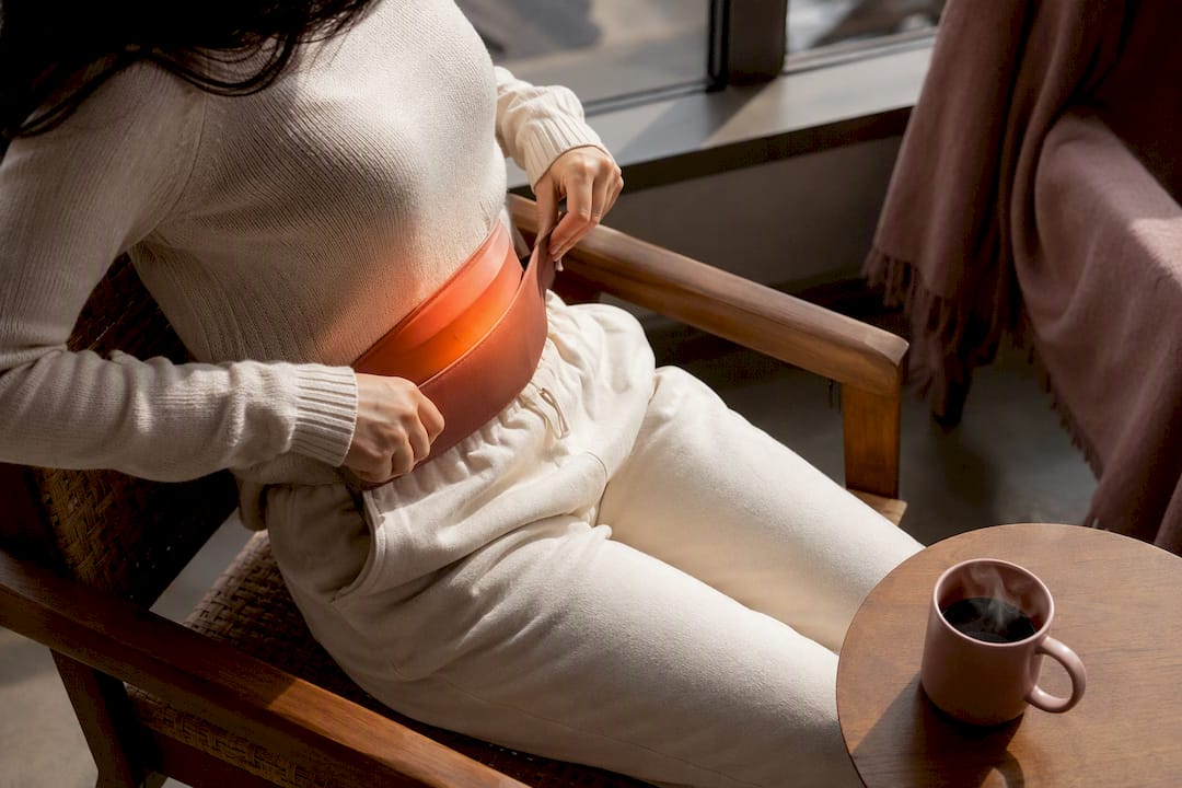 Woman adjusting wearable heating belt discreetly