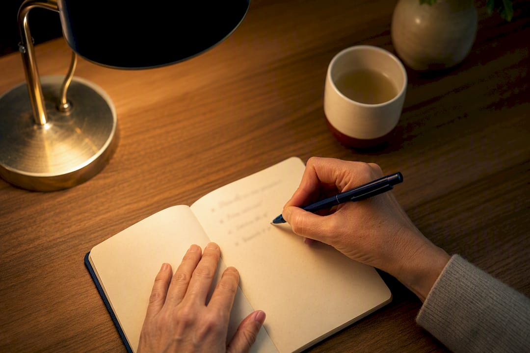Hand writing a pre-sleep to-do list