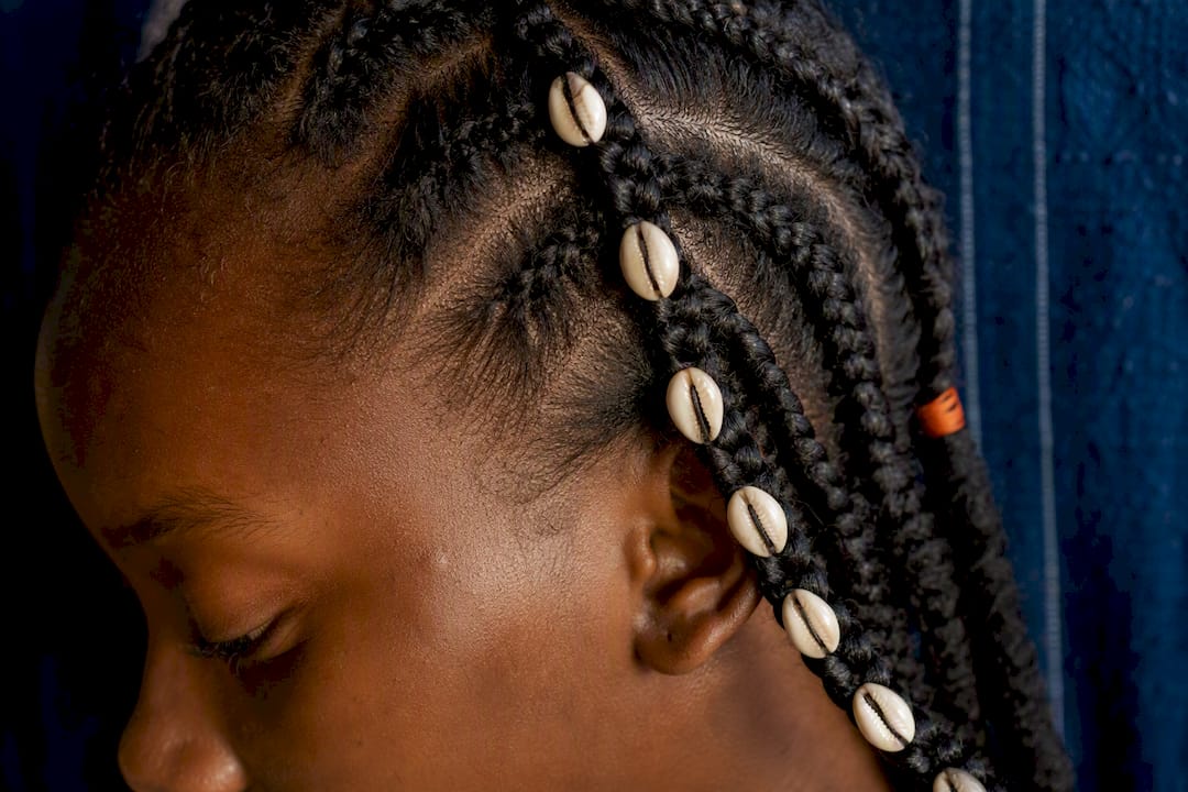 Cowrie shells woven into a Fulani braid