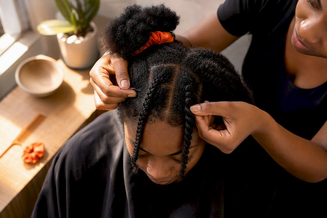 Stylist checking a test braid and twist