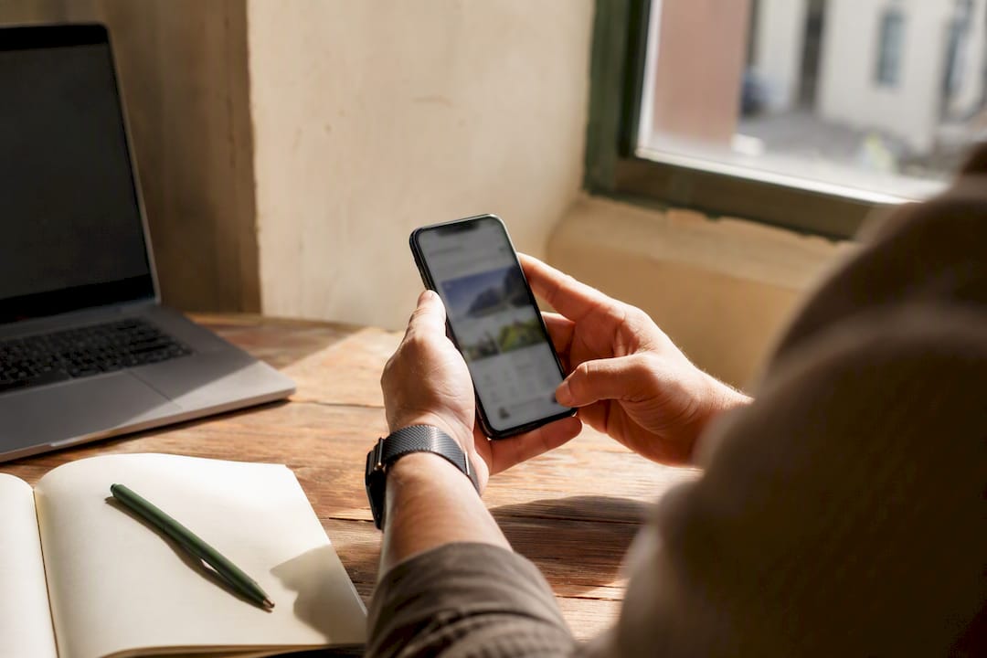 Hands holding smartphone researching local SEO competitor