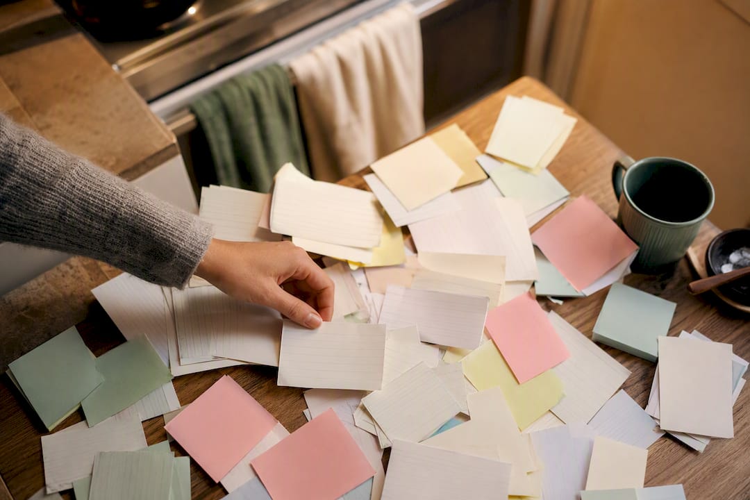 Hand overwhelmed by alerts and sticky notes