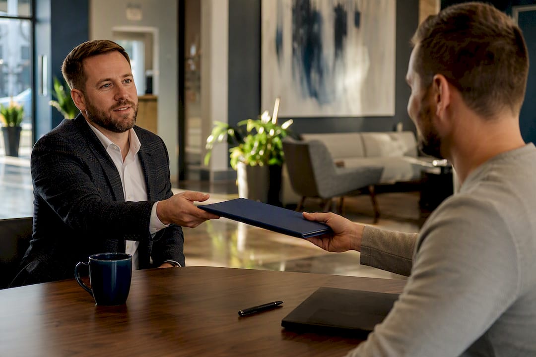 Manager handing monthly report folder