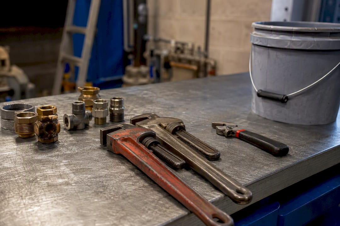 Two plumbing tool sets on maintenance workbench