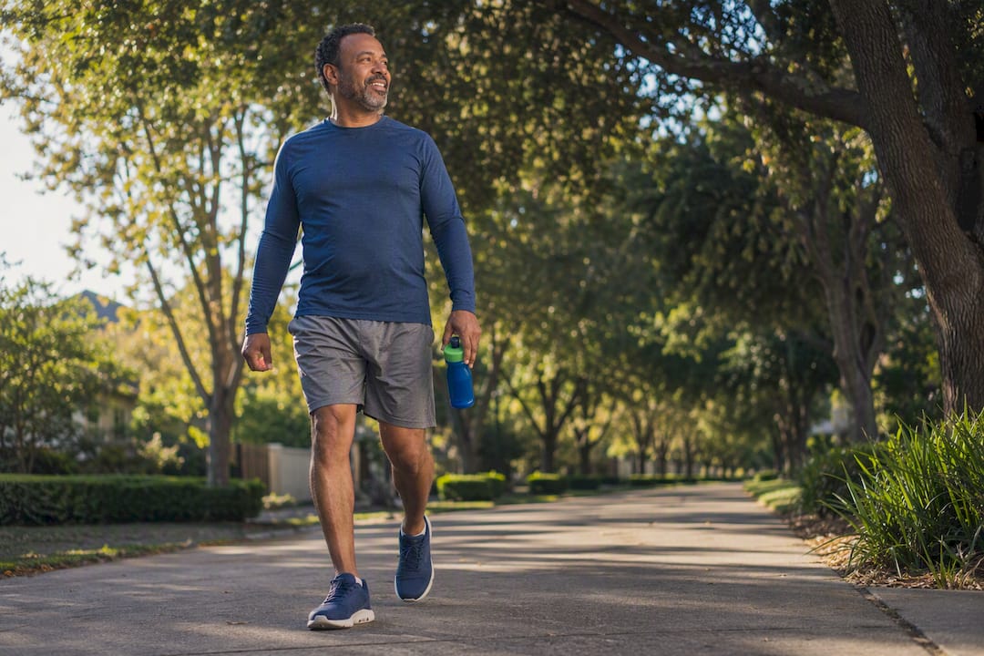 Adult walking briskly on neighborhood path