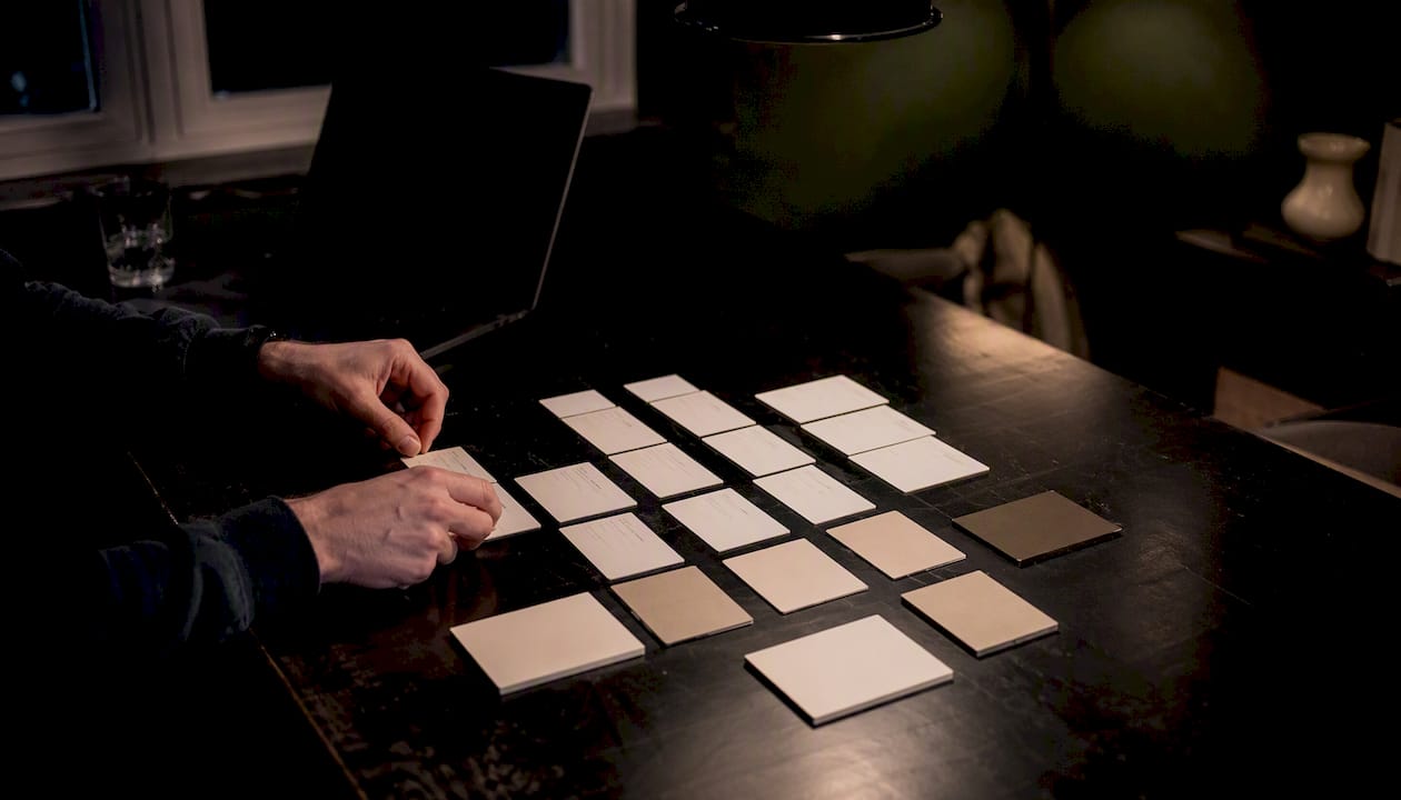 Anonymous hand organizing modular calendar cards