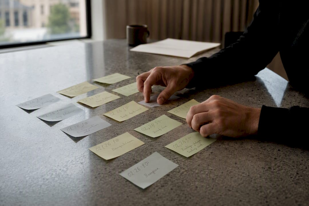 Hands organizing timestamped video feedback notes