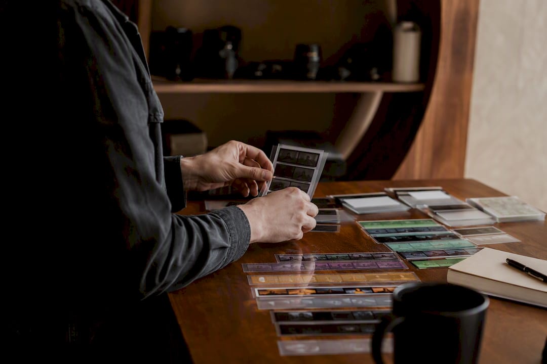 Hands arranging video edit version cards