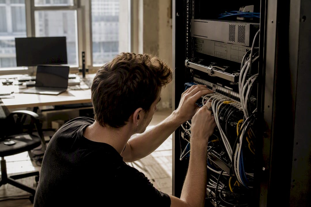 Hands plugging cable in media workspace