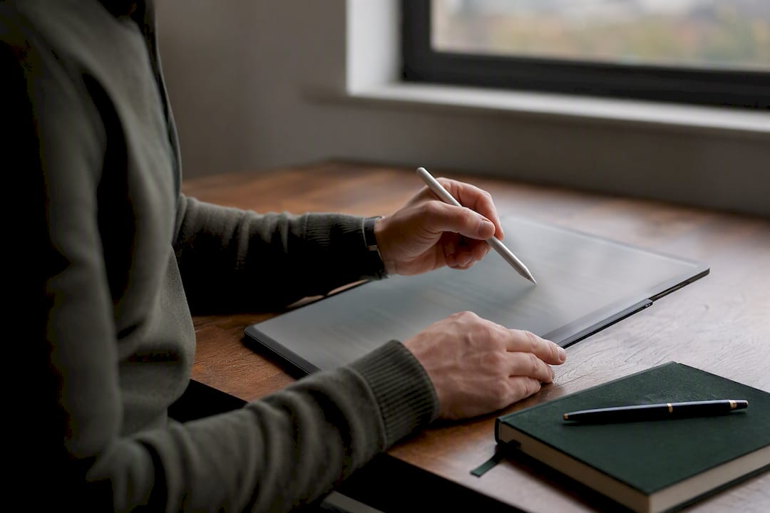 Hands marking content on tablet for GEO