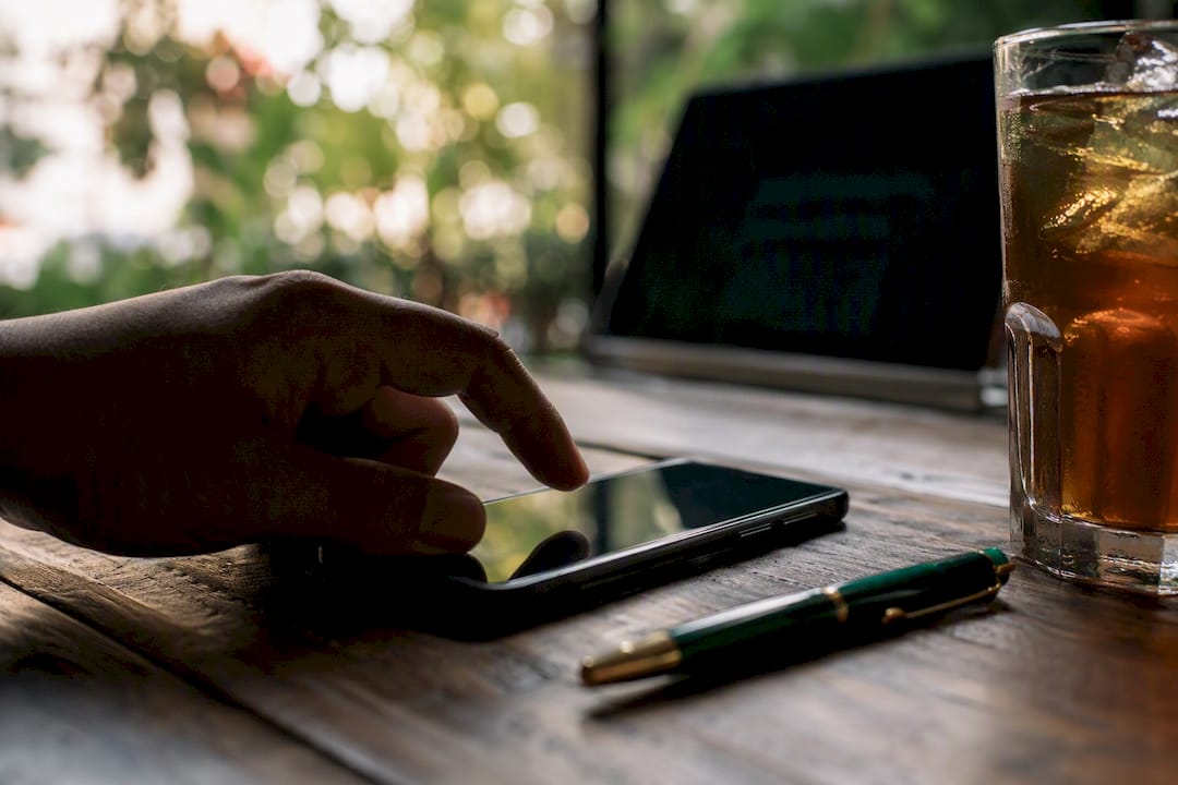 Hand sending targeted outreach message on smartphone