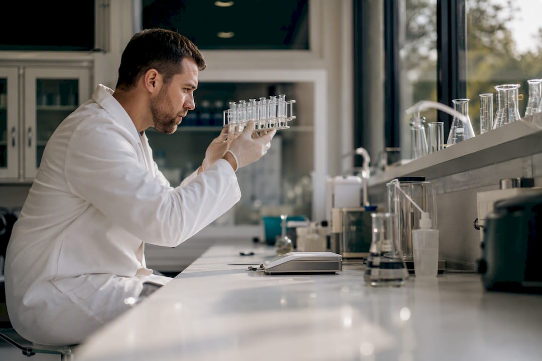 Technician holding supplement test vials