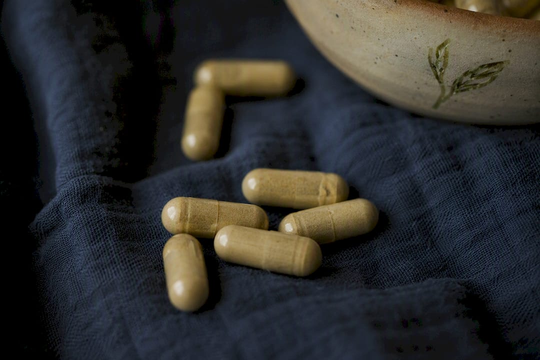 Herbal supplement capsules on navy cloth