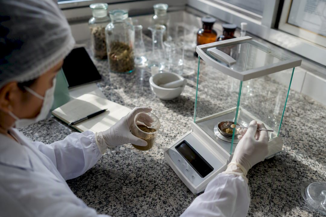 Lab technician measuring herbal powder